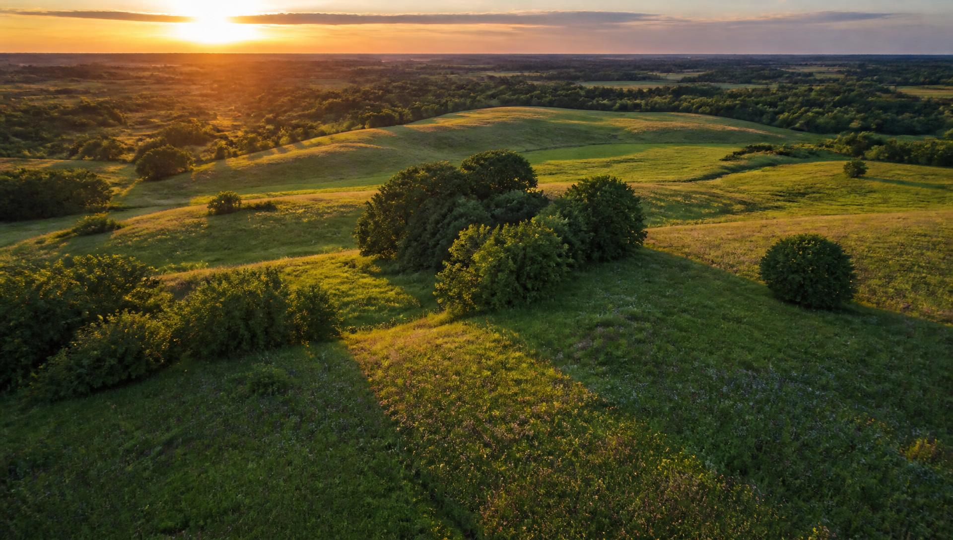 Aerial view of rolling prairie hills at golden hour